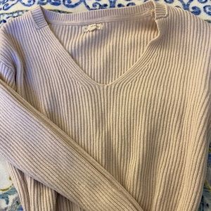 Nude ribbed v-neck sweater cinched at bottom